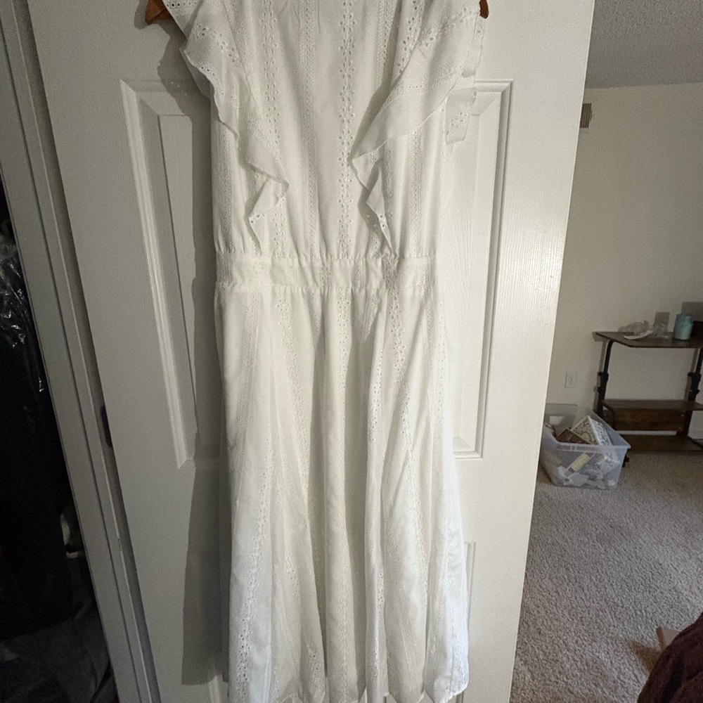 Sleeveless white dress with eyelet detailing